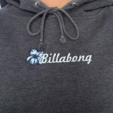 Dark grey hoodie with Billabong spellout on a plain background